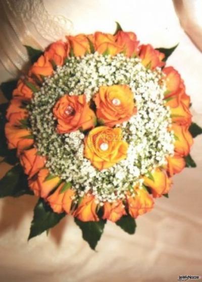 Bouquet per la sposa di rose arancioni e nebbiolina