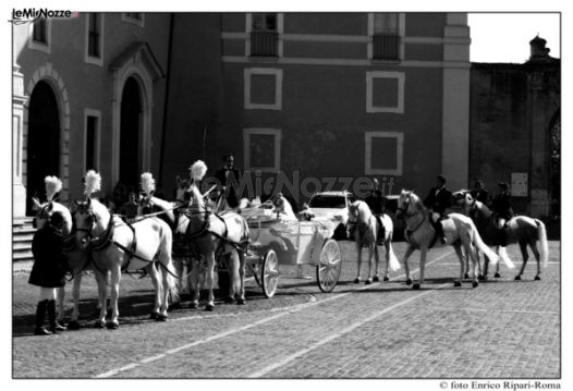 Gli sposi in carrozza d'epoca con quadriglia di cavalli bianchi