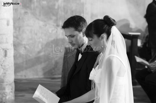 Fotografia degli sposi mentre leggono il rito del matrimo