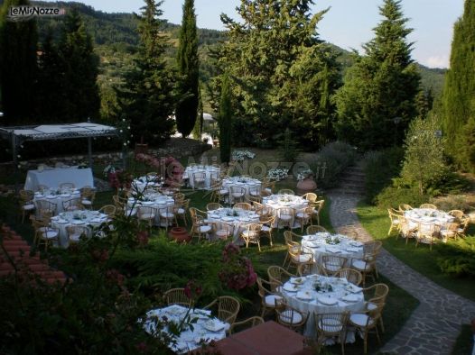 Allestimento tavoli per il ricevimento di nozze in giardino