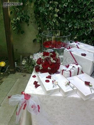 Il tavolo delle bomboniere con rose rosse