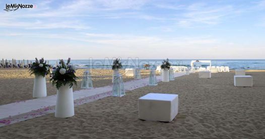Decorazioni floreali con vasi di design per un matrimonio in spiaggia