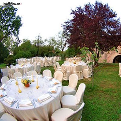 Tavoli allestiti per il ricevimento di nozze nel giardino del castello